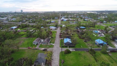 LOUISIANA - CIRCA 2020s - Aerial drone footage of high wind and tornado storm damage of a residential homes in a neighborhood.