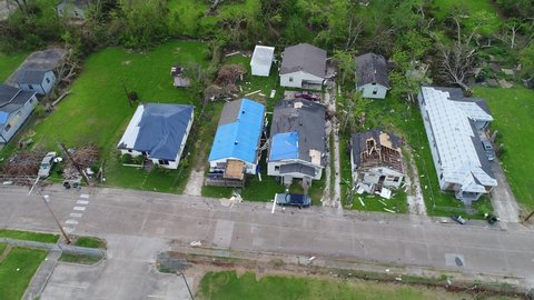 LOUISIANA - CIRCA 2020s - Aerial drone footage of high wind and tornado storm damage of a residential homes in a neighborhood.