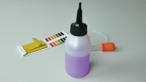 pH measurement in the laboratory with litmus paper by a chemist 