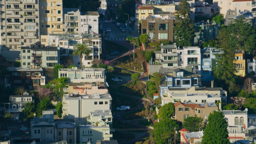 Aerial view of Lombard Street. Famous crooked street with eight hairpin turns. Several buildings located in Russian Hill an upscale residential neighborhood. San Francisco, California. US. Shot in 8K. Royalty-Free Stock Footage #1075121210