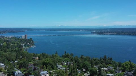Drone flying over Madison Valley in Seattle wit Lake Washington, North Cascades, 520 Bridge and Kirkland views.