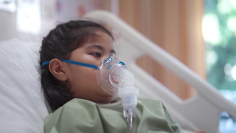 Asian girl 7-year-old in hospital using inhaler containing medicine, RSV, Respiratory Syncytial Virus