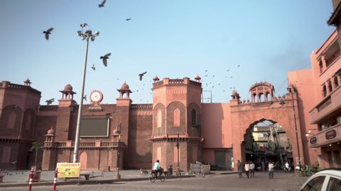 Amritsar, Punjab - 06-07-2021: Entry gate of old Amritsar city market. Old fort wall around Amritsar city market. old Traditional market in India. Pigeons flying over city market.