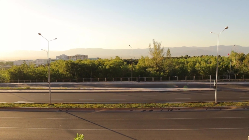 Traffic on highway with cars, a park background.
At sunset motor Traffic on the Motorway seen from above.
City.