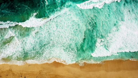 Aerial Directly Above Crashing Waves On The Shore Of A Sandy Beach, With Turquoise Colored Water, White Sea Foam, And Bright Sand - Oahu, Hawaii Stockvideó