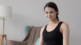 Online workout woman greets followers with namaste at video 
