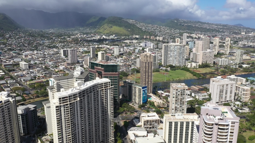 Cinematic 4K aerial drone pan shot of the Hawaiʻi Convention Center, hotels, condominiums, apartments, offices on the West side of Waikiki near Honolulu on Oahu island, Hawaii known for its beaches