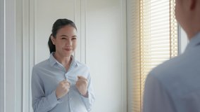 Young female leader, asia people lady or mba student happy standing smile look at in front of mirror pep talk for sale pitch hold paper document script public speak skill for job career self improve. - Powered by Shutterstock - Get 15% off with code: PIKWIZARD15