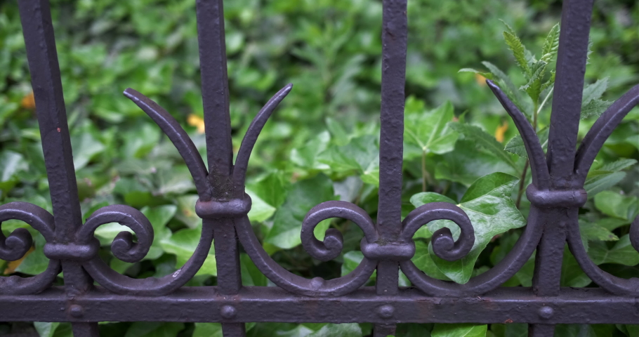 Pan right- slider move along an antique metal fence in Zurich, Switzerland