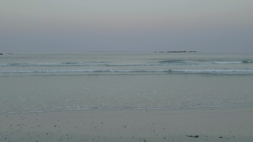 Panning from Robben island to Table Mountain in Cape Town, South Africa on a summer morning during sunrise