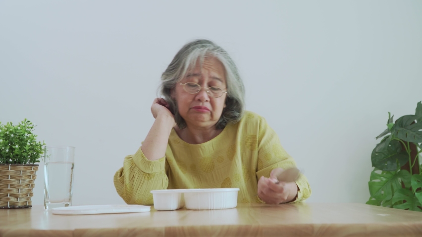 Unhappy Asian senior woman anorexia and say no to ready meals, Elderly home alone and bored food and no appetite | Shutterstock HD Video #1075184630