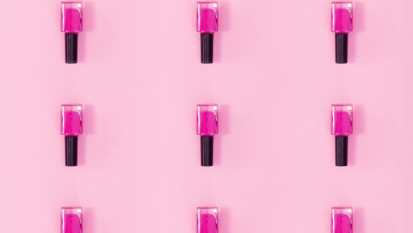 6k Beauty concept pattern made of nail polishes bottles in same color rotate on bright pink theme. Stop motion Royalty-Free Stock Footage #1075188200