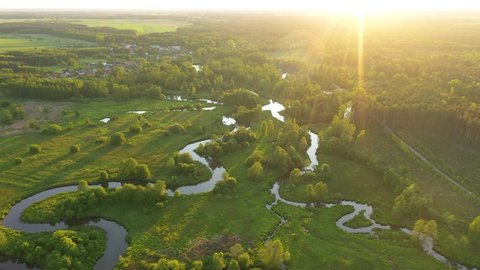 Drone aerial shot of natural river during sunset