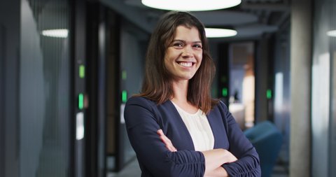 Portrait of smiling caucasian businesswoman with brown hair in modern office. business and business people in office concept.