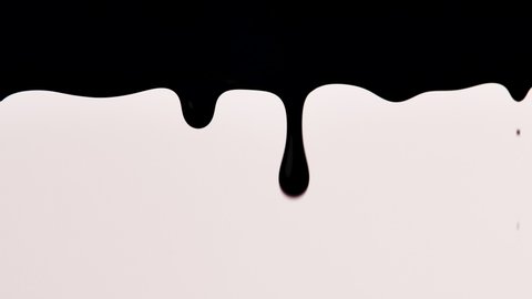 Black paint slowly drips down on white background. Dynamic animation of thick liquid dripping down. Drops ink. Spilling paint. Graphic wallpaper with spilled paint effect.