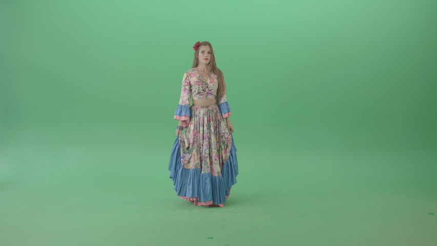 Roma gipsy woman dancing in colorful costume. Beautiful woman, dressed in colorful gypsy authentic clothes, perform the traditional gypsy Roma dance. Royalty-Free Stock Footage #1075215866