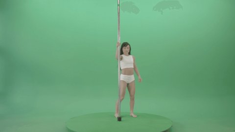 Small Girl make spin pole fly. Fit pole dancer girl in white underwear performing a rousing contemporary dance moves on pylon on green chromakey background.