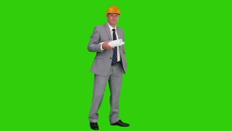 Businessman is working on a building project against a green screen