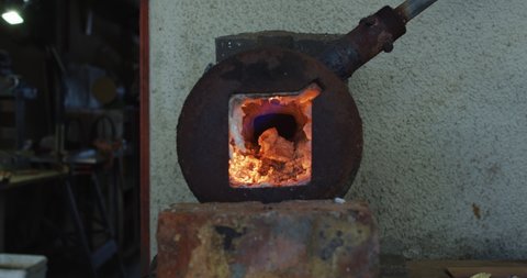 Close up of fire in oven in knife maker workshop. independent small craft business at work.