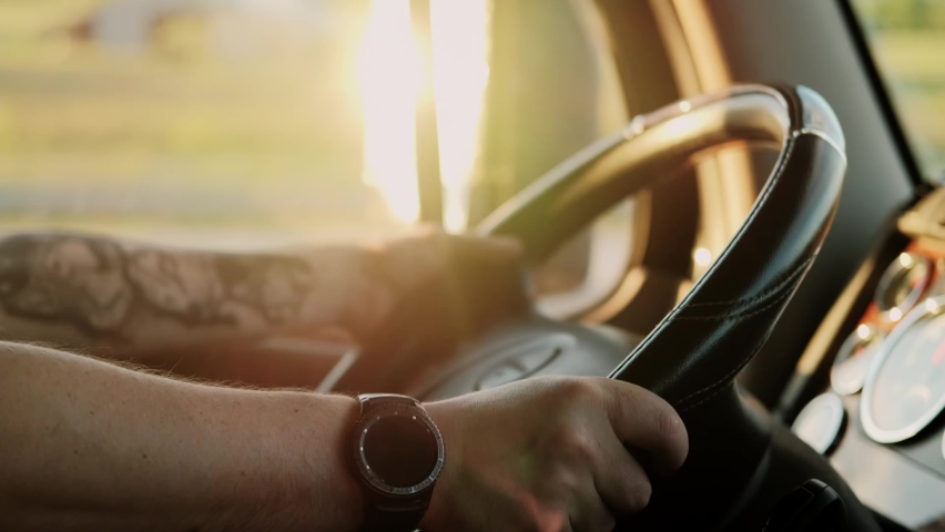 Close up. Truck driver rides to destination cargo . Driving truck at road on warm summer day and with reflections of sunlight in the mirror. Slow motion Royalty-Free Stock Footage #1075247987