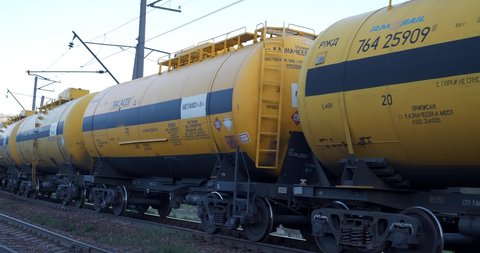 SLAVSKE, UKRAINE, MAY 10, 2021: Freight train with yellow cisterns with methanol rides on rails