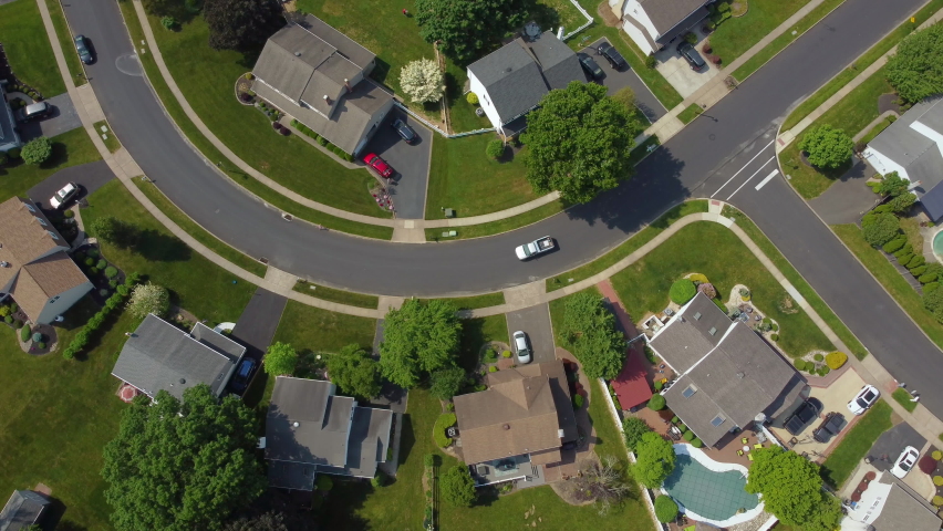 Aerial of a white truck driving through a suburban neighborhood from above | Shutterstock HD Video #1075256438