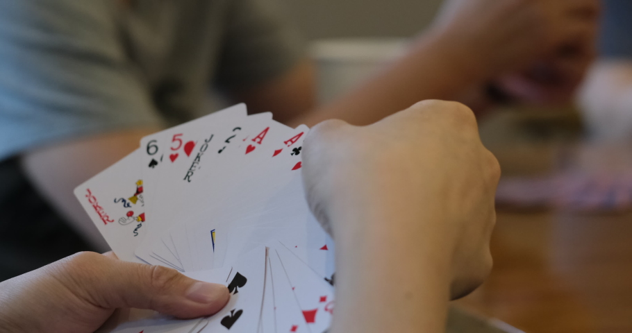 close up hand holding poker cards. blur background