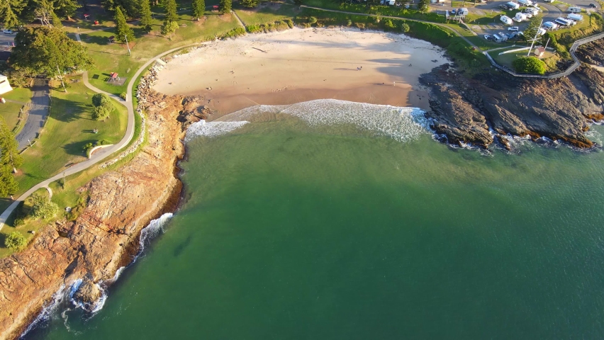 Waves On Sandy Shore Of Horseshoe Bay Beach During Golden Hour - Point Briner Peninsula At South West Rocks On Mid North Coast Of NSW, Australia. - aerial
