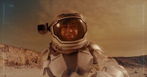 Woman in space suit waving hand and gesturing thumb up while talking about life on Mars for video diary recording with blue interface