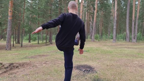 Training in the forest. Martial arts in the forest. Sports in the forest.