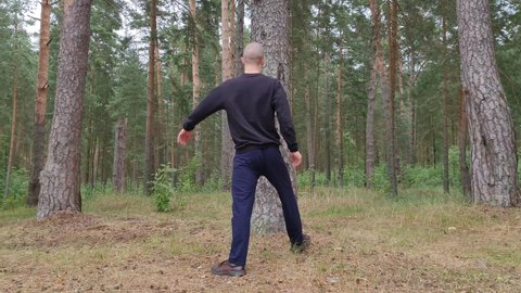 Training in the forest. Martial arts in the forest. Sports in the forest.