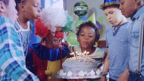 Animation of confetti falling over clown and children blowing candles on birthday cake at party. childhood, party and celebration concept digitally generated video. - Powered by Shutterstock - Get 15% off with code: PIKWIZARD15