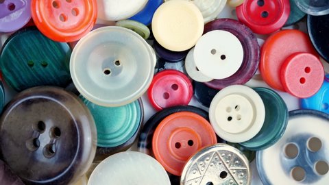 sewing buttons. close-up. rotation. Various round colored sewing buttons rotate on turntable. Loop motion background. concept of color, fashion, dressmaking, sewing, tailor.