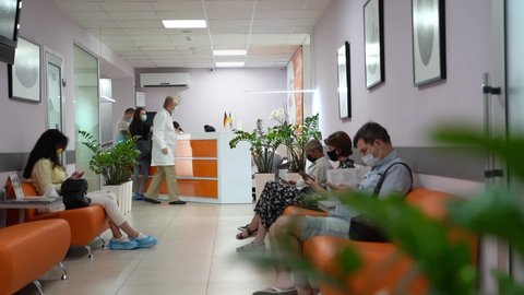 waiting for a doctor's appointment. a group of patients are sitting on the couch in the clinic, waiting in line.
June, 30, 2021, Kyiv, Ukraine