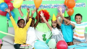 Animation of gold confetti falling over diverse happy children and clown having fun at party. celebration, birthday, party, childhood and event concept digitally generated video.