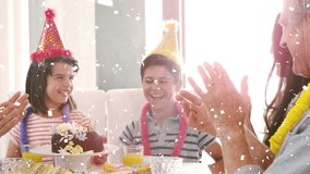 Animation of confetti falling over family having fun at birthday party. childhood, party and celebration concept digitally generated video.