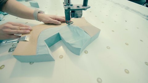 Razor device is being used to cut out a fabric pattern