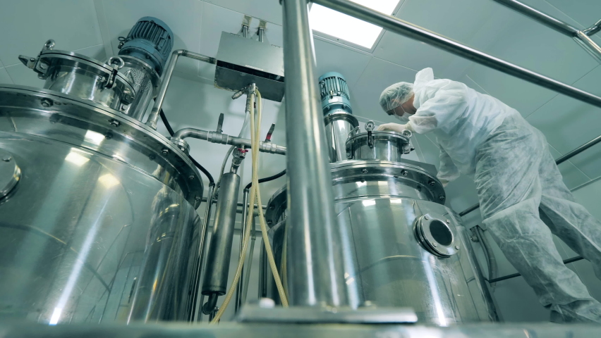 Pharmacology specialist is working with chemical reactors | Shutterstock HD Video #1075297805