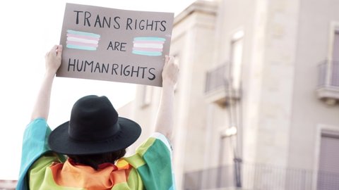Transgender people at gay pride holding trans human rights flag banner - Lgbt celebration event concept