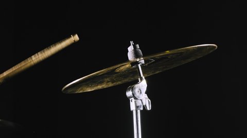Studio cymbal crash double stroke. drumkit stick hits cymbal crash. drummer playing on drum kit on stage or in a dark studio with muffled lighting. Performance vocal and musical band