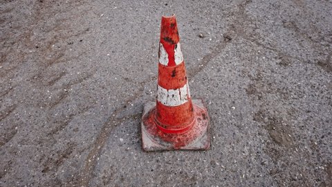 Traffic road cone on the asphalt, damaged Traffic cone orbiting shot