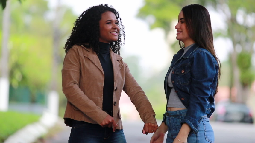 Two diverse women talking and chatting outside, a Person Video by Bricolage