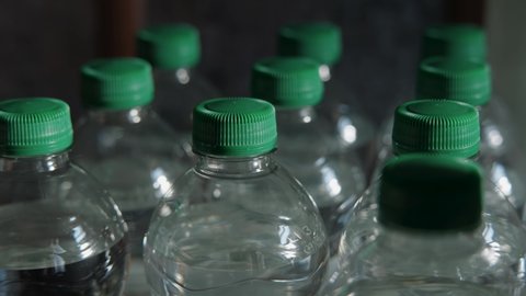 Man Storing Water In Plastic Bottles, Survivalist Concept.