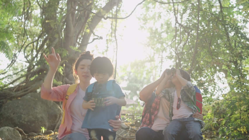 The Asian family Father and mother brought two sons Hiking using binoculars For education Learn nature on vacation at the nature study center. Royalty-Free Stock Footage #1075335206
