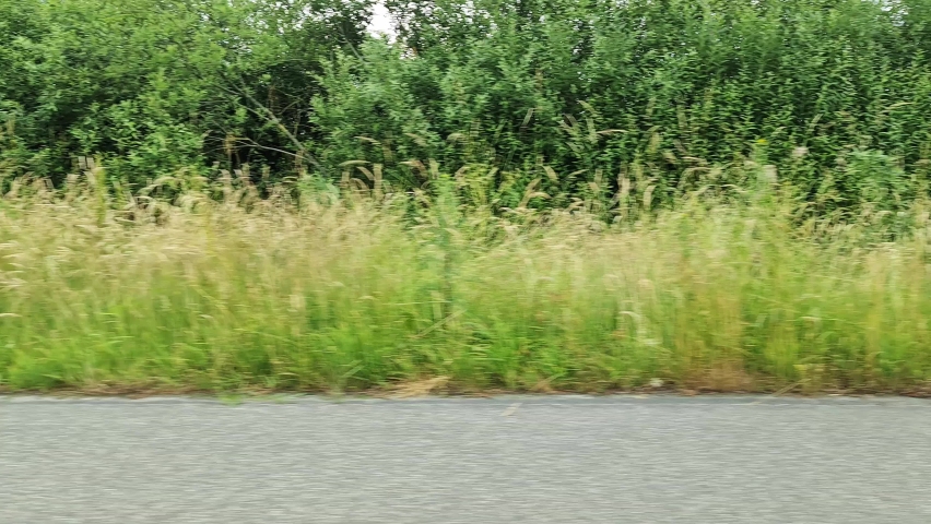 Motion blurred view out of the side window of a driving car on a highway in germany