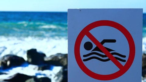 sea coast is closed, finish on bathing season sign outdoors