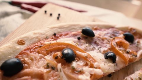 Sliced ​​pizza with olives on the table