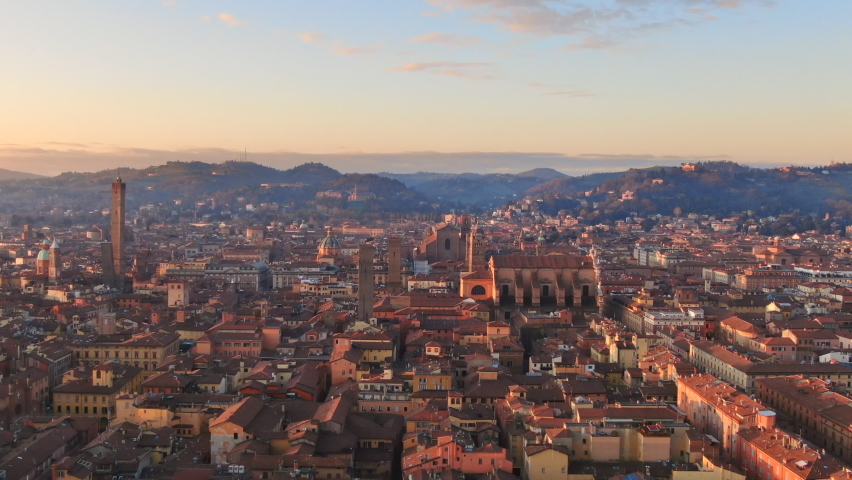 bologna skyline aerial view drone flying sideways over historic city center,italian town cityscape at dawn shot at sunrise,emilia romagna italy 4k Royalty-Free Stock Footage #1075344854