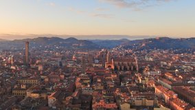 bologna skyline aerial view drone flying sideways over historic city center,italian town cityscape at dawn shot at sunrise,emilia romagna italy 4k