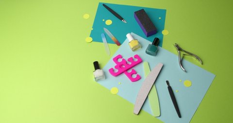 Set for manicure and pedicure on color background, video with stop motion effect